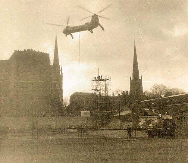 Helicopter about to lift the flèche